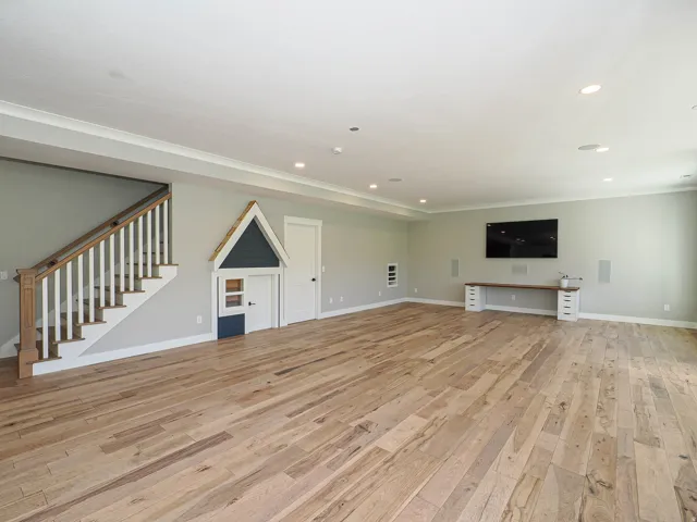 Spacious entertainment area featuring wide plank wood-finish flooring