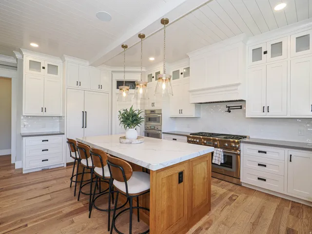 Kitchen island with a white countertop and natural wood-finish base