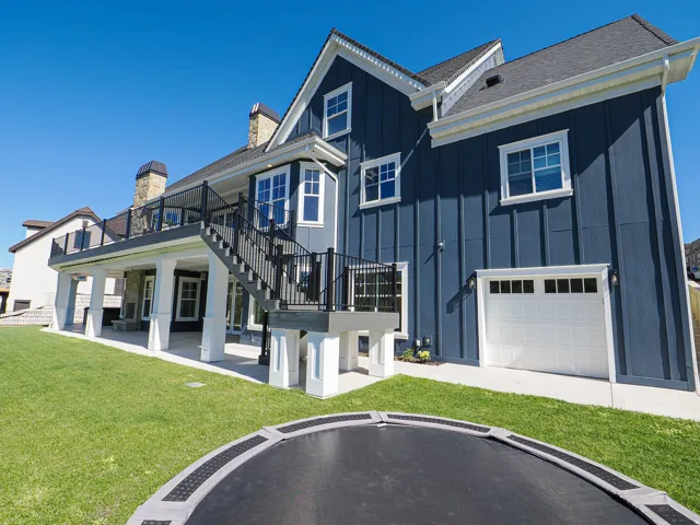 Deep blue vertical siding exterior with white trim
