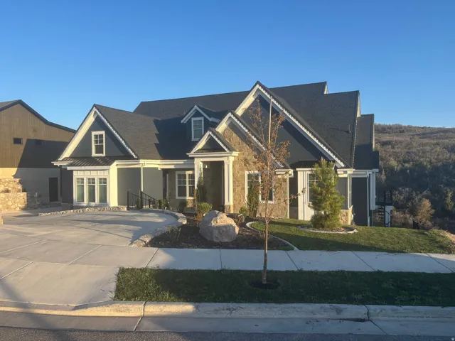 Stone and siding exterior with gabled roof lines