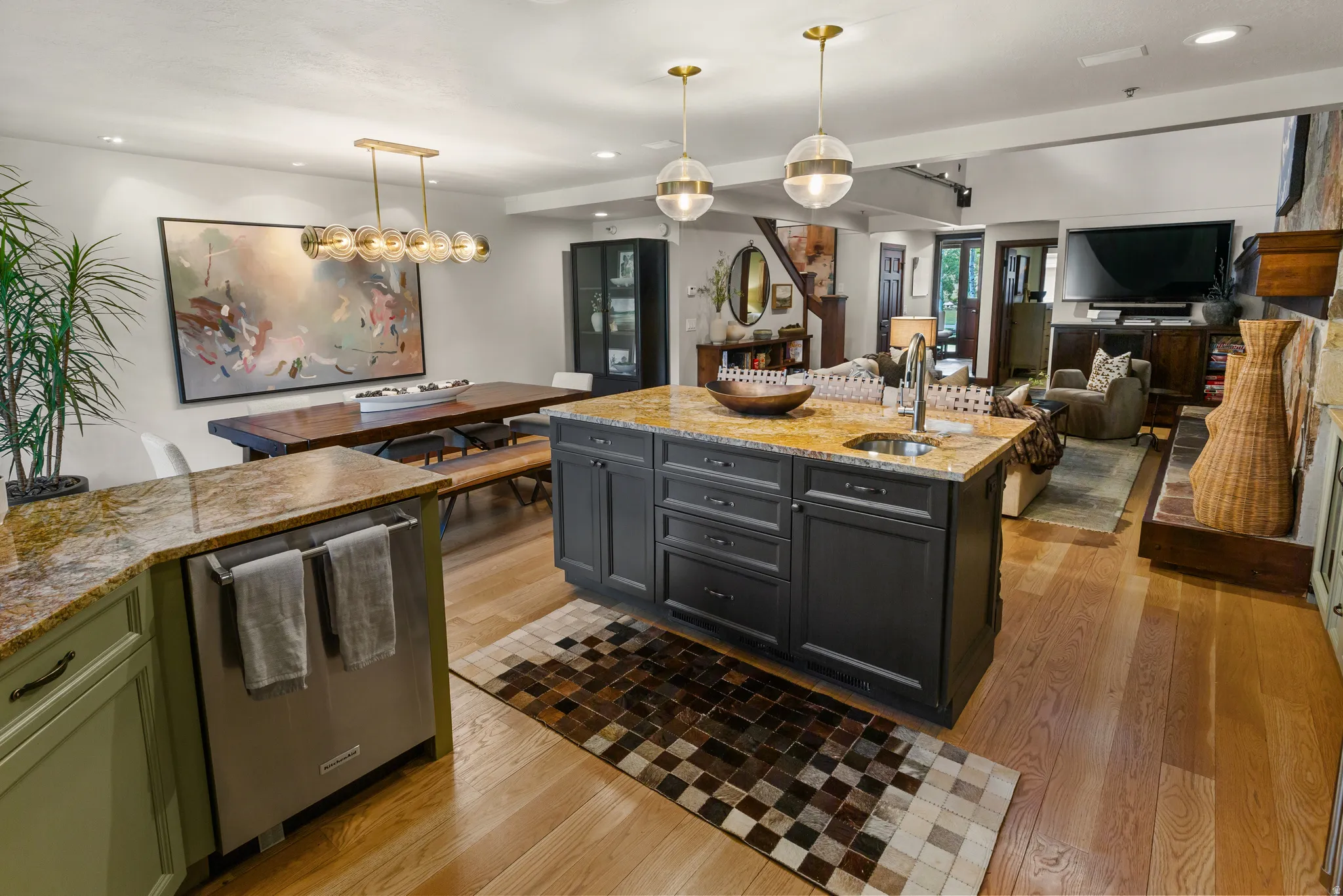 Open-concept kitchen and living area featuring wood-finish flooring