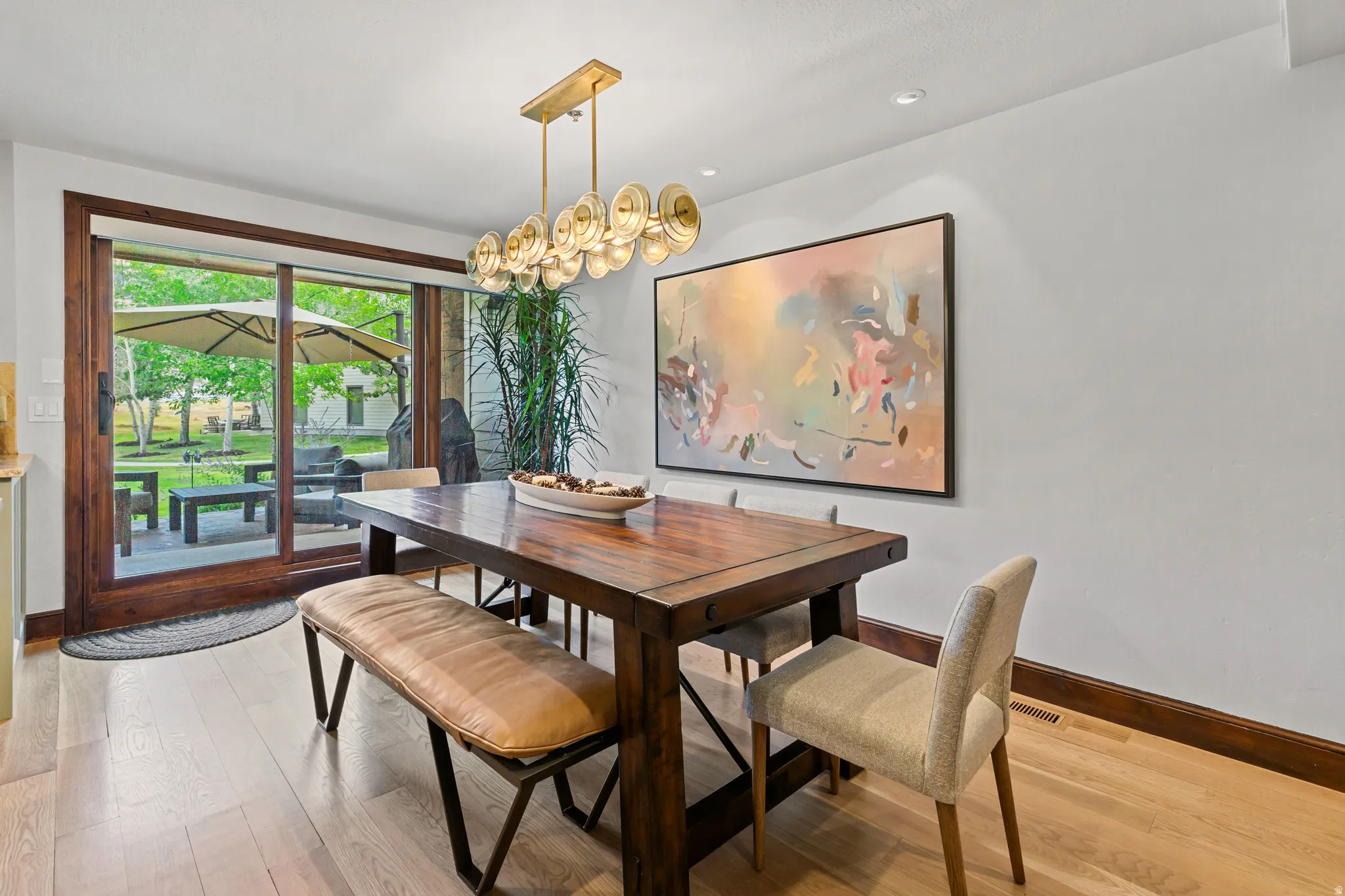Dining area featuring light wood-finish flooring, white walls, and dark wood trim