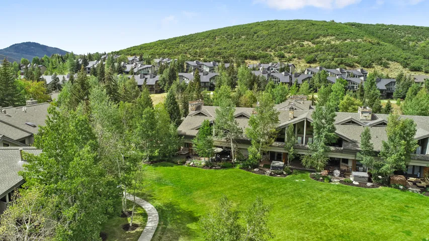 Expansive property featuring a multi-level structure with gabled roofs and stone chimneys
