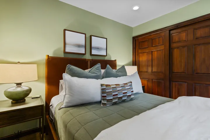 Bedroom featuring warm green walls and recessed ceiling lighting
