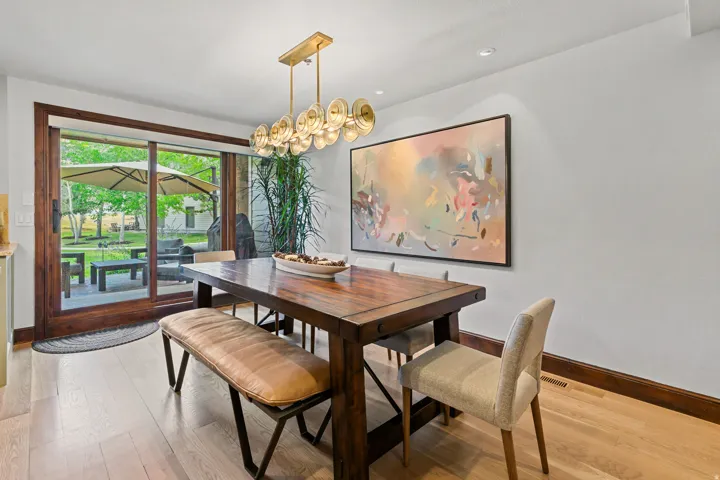 Dining area featuring light wood-finish flooring, white walls, and dark wood trim