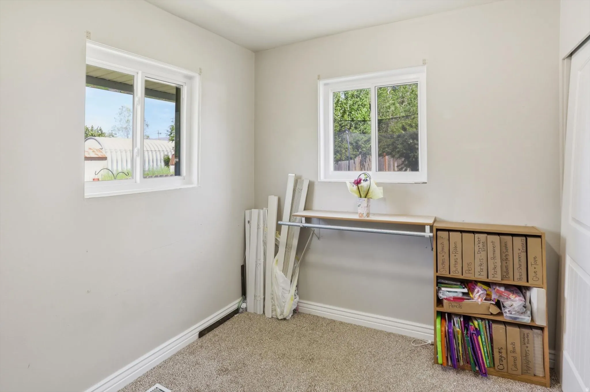 Neutral-toned walls complement the carpeted flooring
