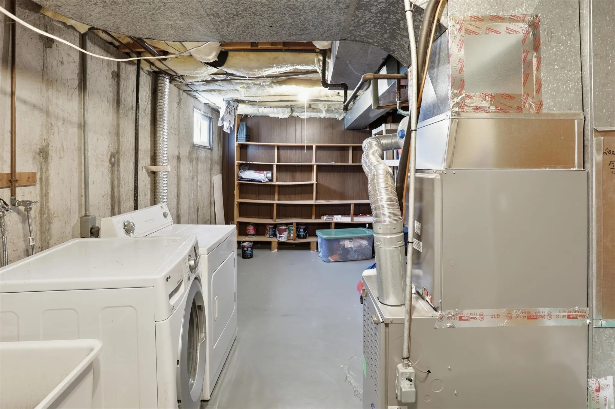 Basement utility area featuring concrete walls and a painted concrete floor