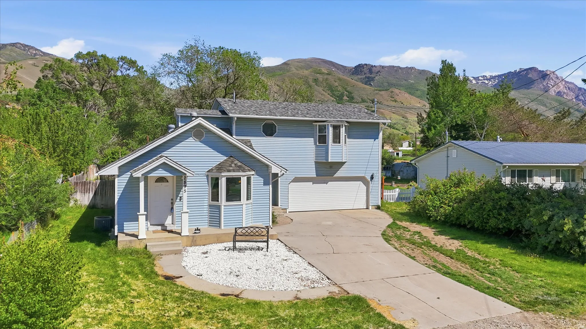 Light blue siding exterior with a white front door and covered entry