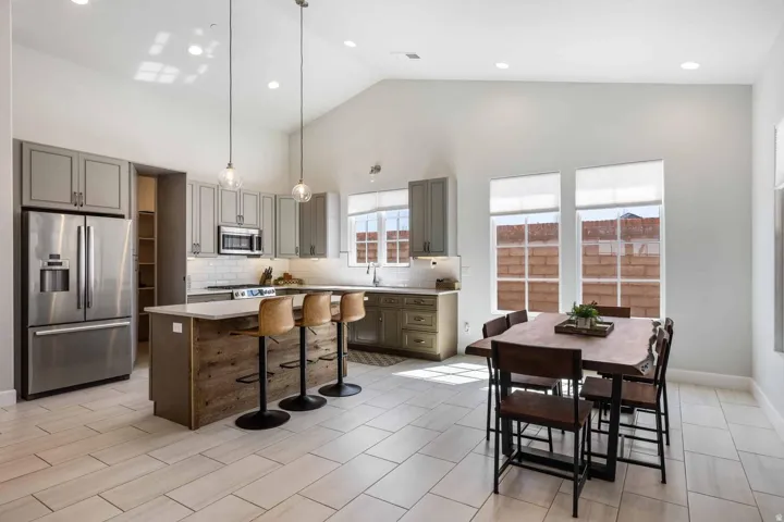 Vaulted ceilings define this open-concept kitchen and dining area