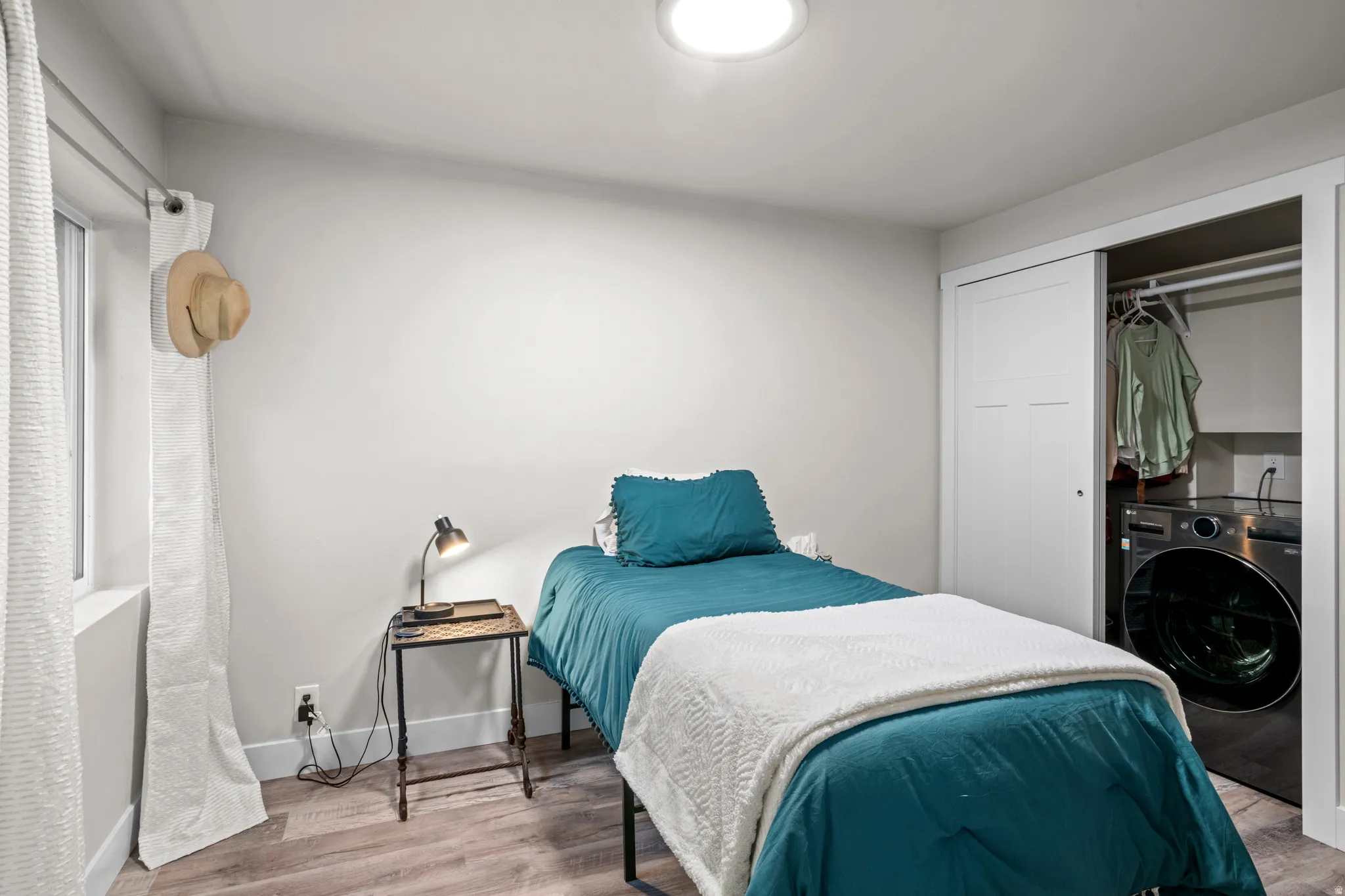 Basement bedroom. Note washer/dryer combo unit in closet.