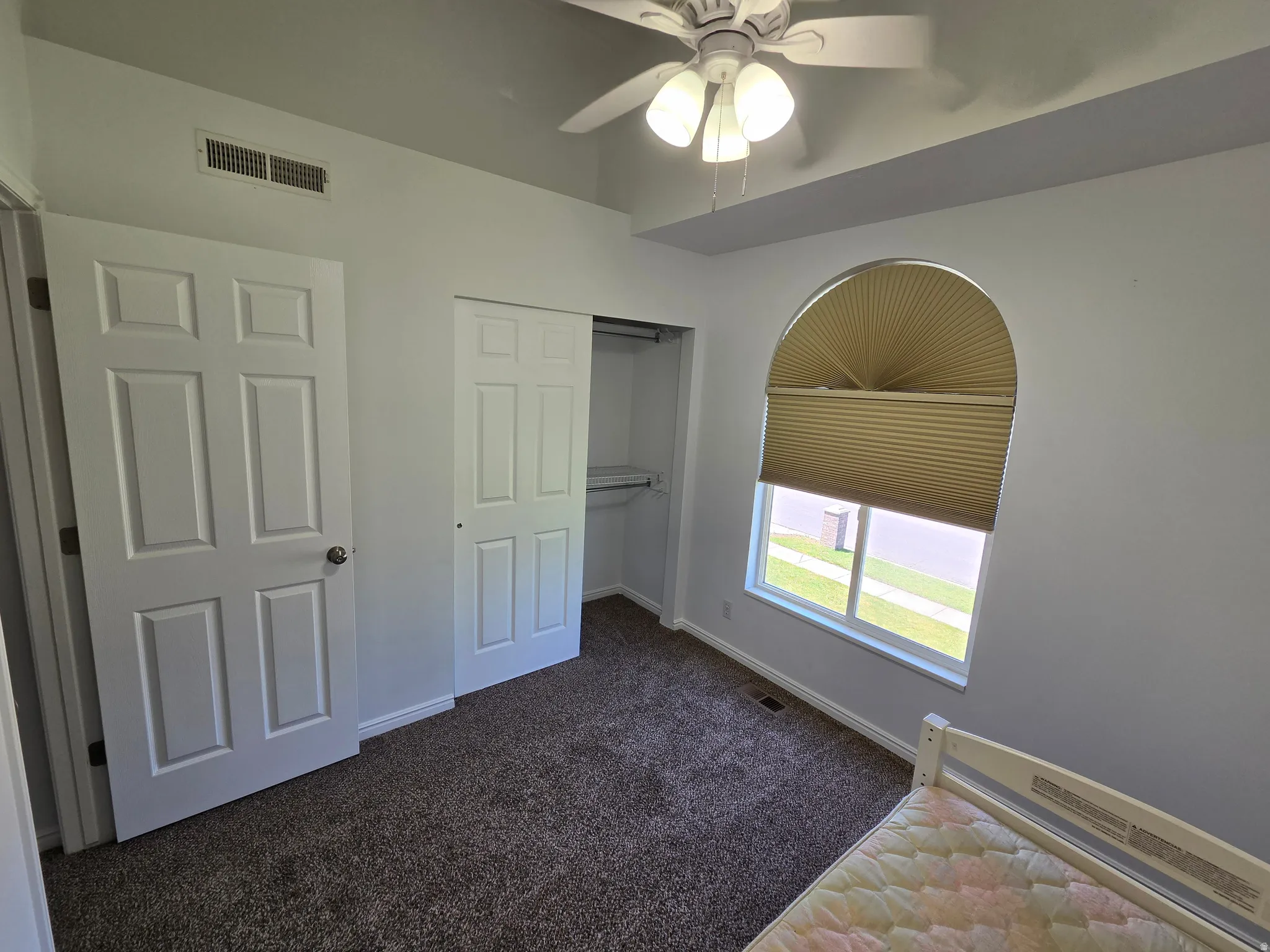 Room featuring a vaulted ceiling and a ceiling fan