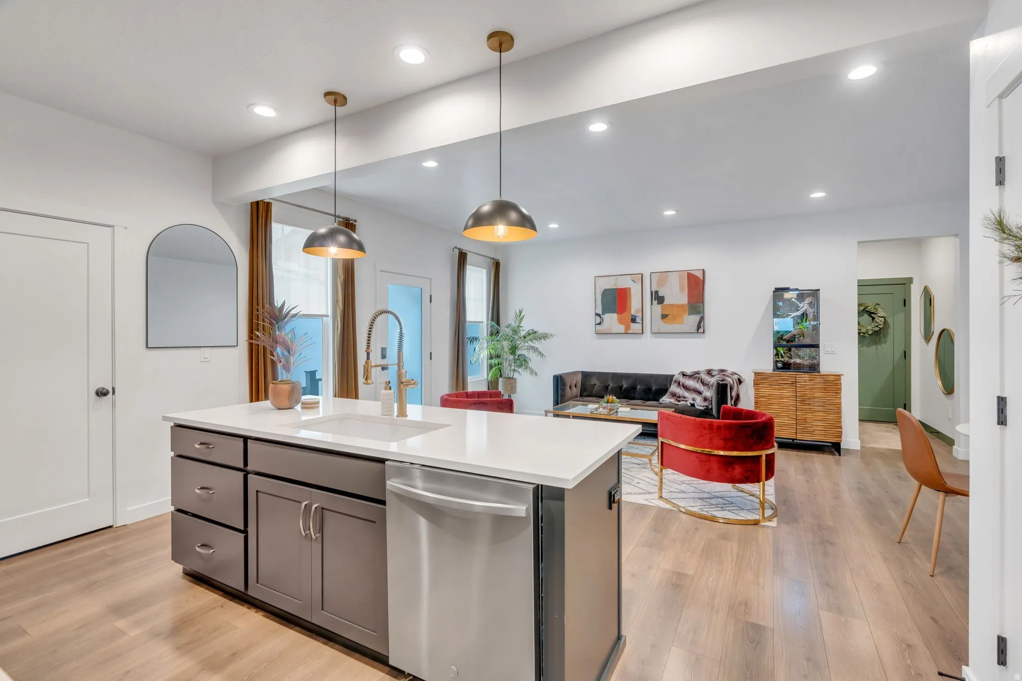 Kitchen island with an undermount sink and stainless steel dishwasher