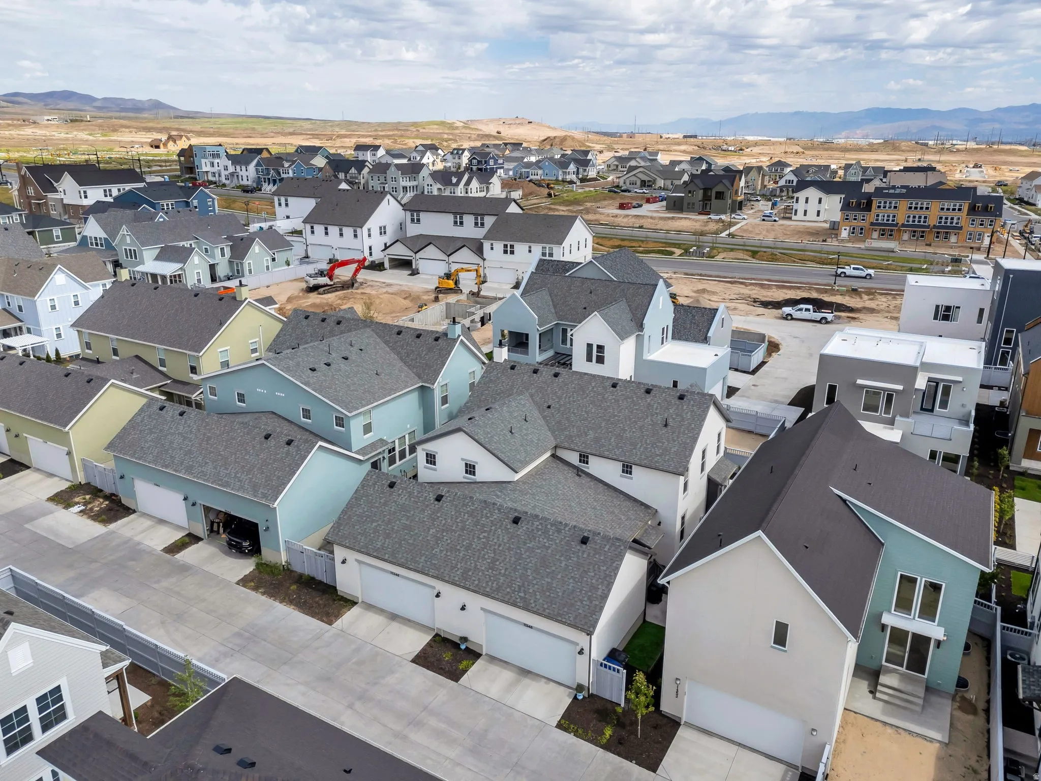 Residential development featuring a variety of single-family homes with pitched roofs and attached garages