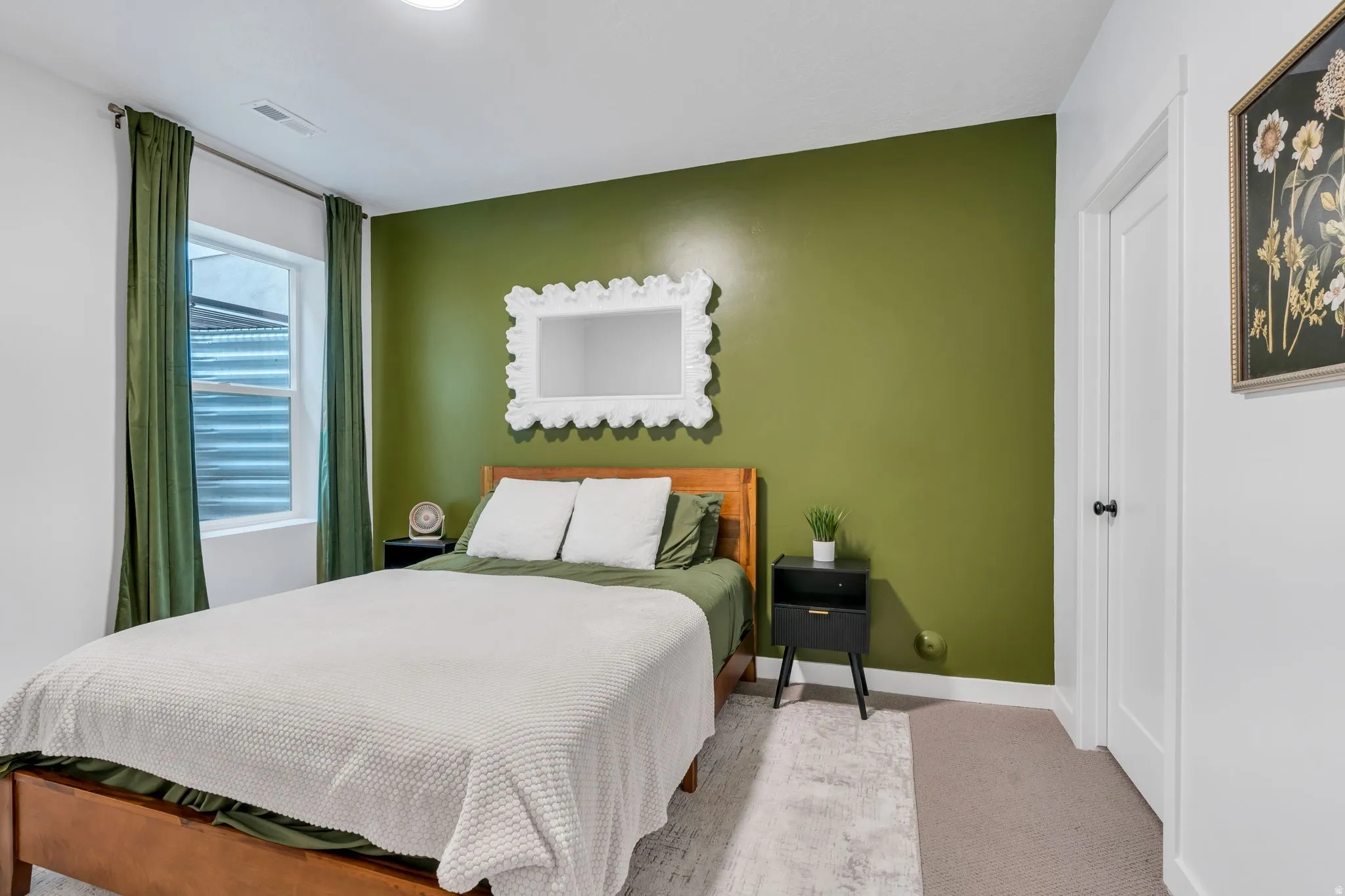 Bedroom featuring a prominent accent wall, a contrasting white door, and a horizontal window with blinds