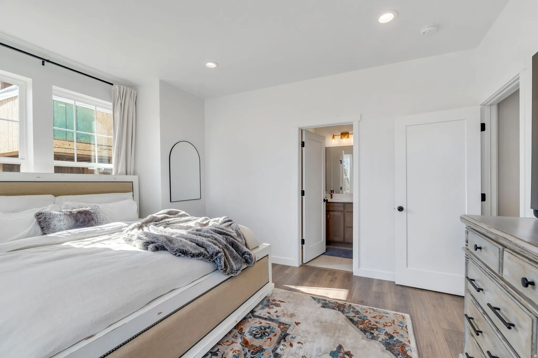 Bedroom with recessed lighting and wood-finish flooring