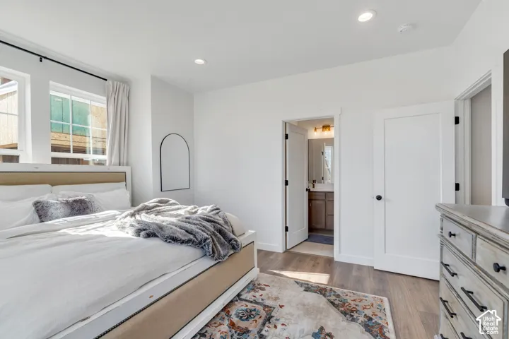 Bedroom with recessed lighting and wood-finish flooring