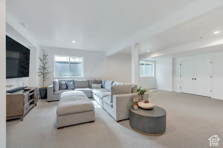 Spacious lower-level area featuring light-toned carpeting and recessed lighting