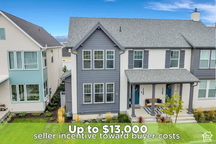 Multi-level exterior featuring a combination of stucco and horizontal lap siding, a pitched roofline, multi-pane windows, and a covered front porch with column supports