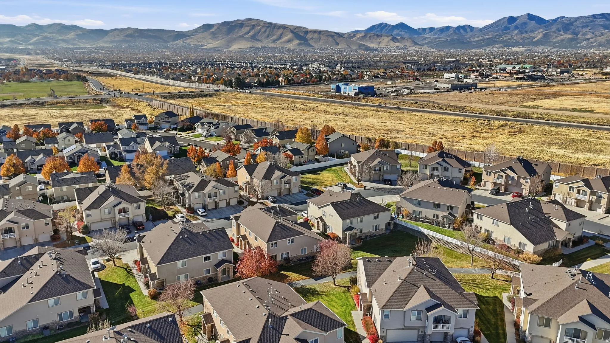 Expansive residential area featuring numerous multi-story homes with dark roofs and light-colored siding