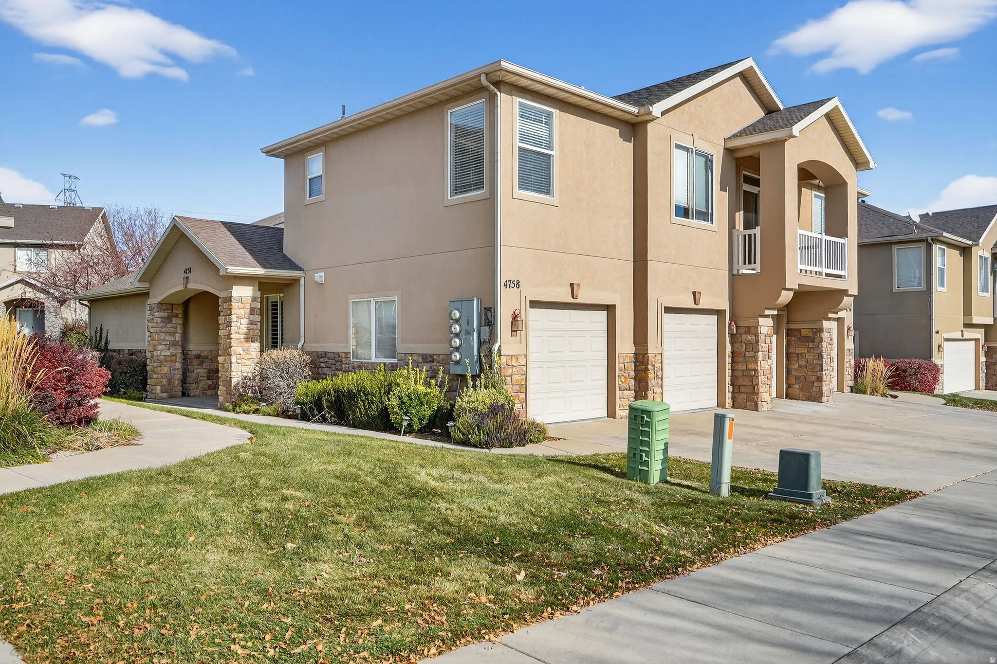 Stucco exterior with stone accents and multiple attached garages