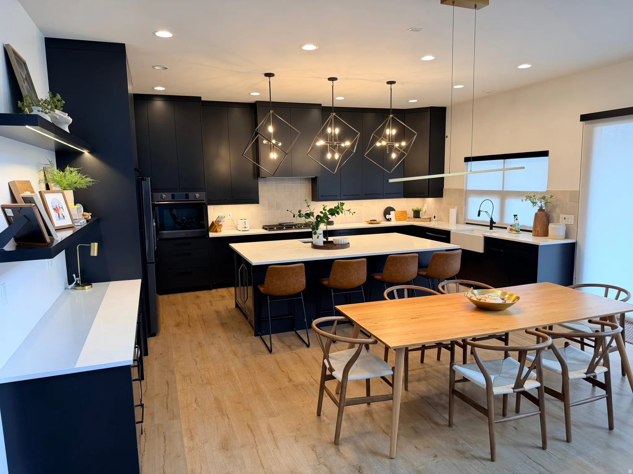 Open-concept kitchen and dining area featuring light wood-finish flooring