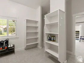 White shaker-style window shutters and built-in shelving units