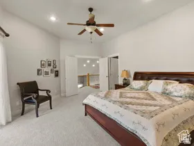 Vaulted ceiling with recessed lighting and ceiling fan