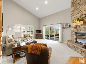 Spacious living area featuring a vaulted ceiling and recessed lighting