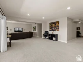 Spacious carpeted room featuring recessed lighting, light-toned walls, and white trim