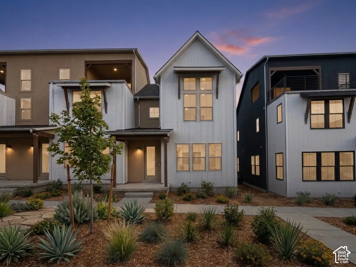 Modern farmhouse-style exterior with vertical siding, gabled roofline, and prominent multi-pane windows