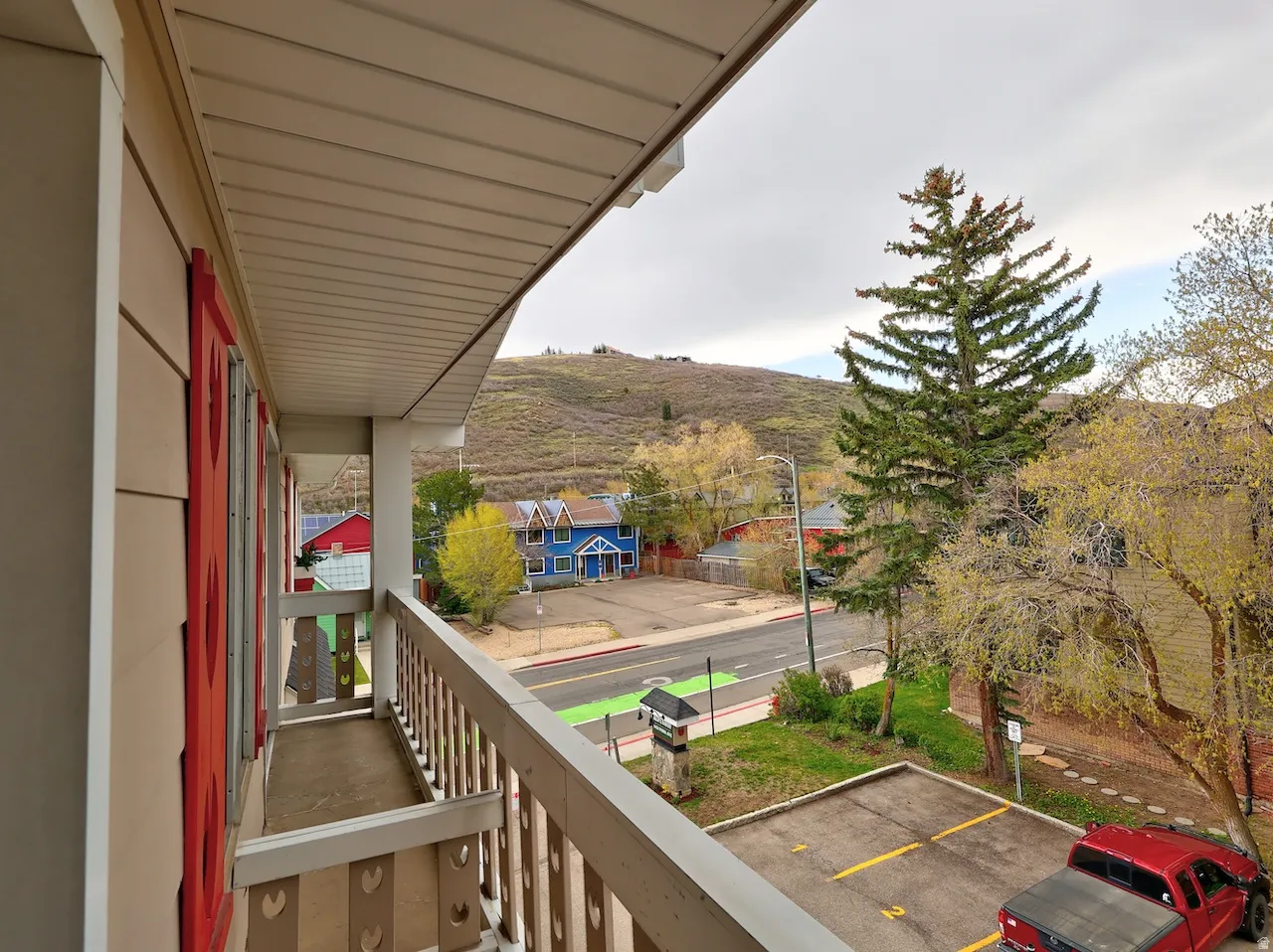 Private balcony with wood railing and mountain backdrop