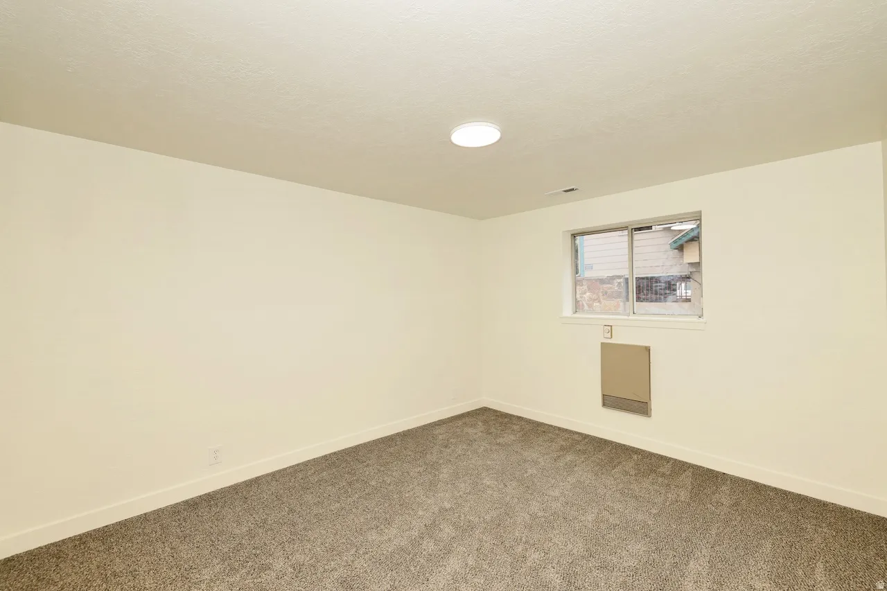 Neutral-toned walls complementing plush grey carpeting