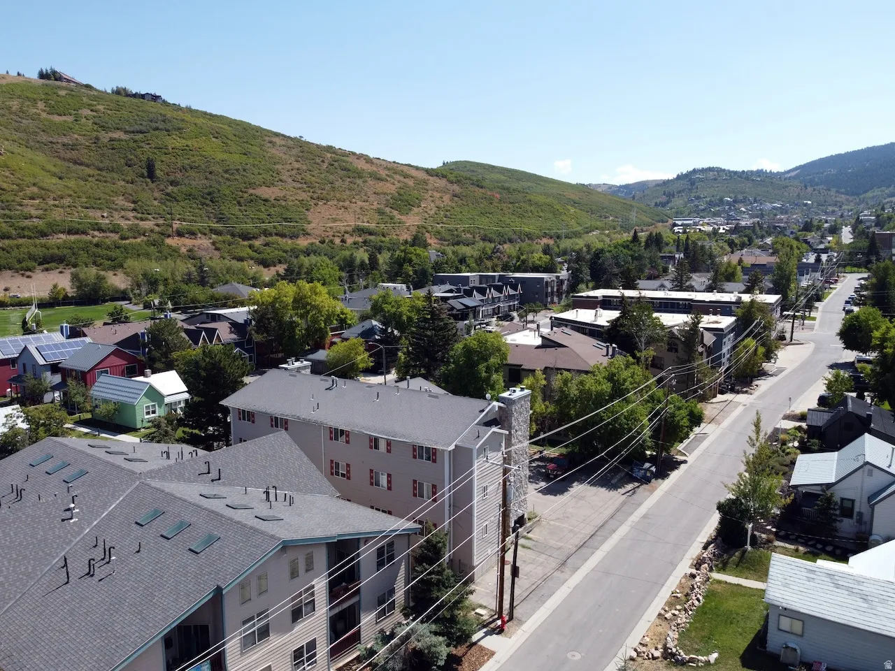 Aerial perspective showcasing a community nestled against a verdant hillside