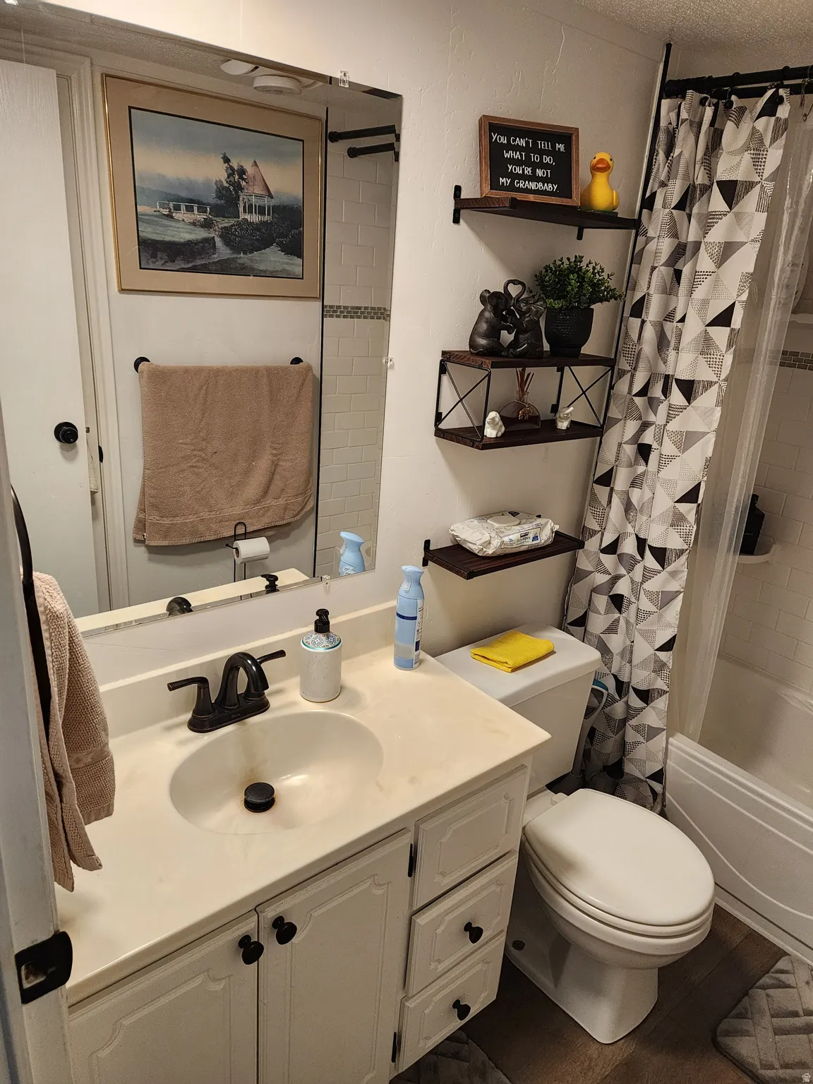 Bathroom vanity with integrated sink, black faucet, and white cabinetry