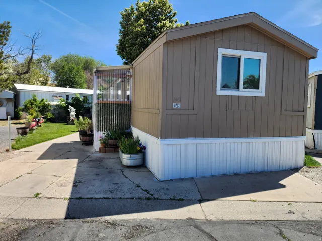 Exterior featuring horizontal siding, white trim, a single window, and a white skirting foundation