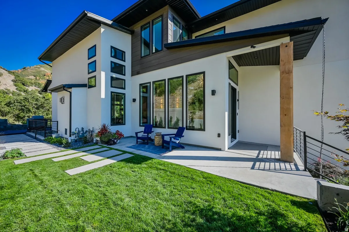 Modern architectural exterior featuring white stucco and dark wood-finish siding