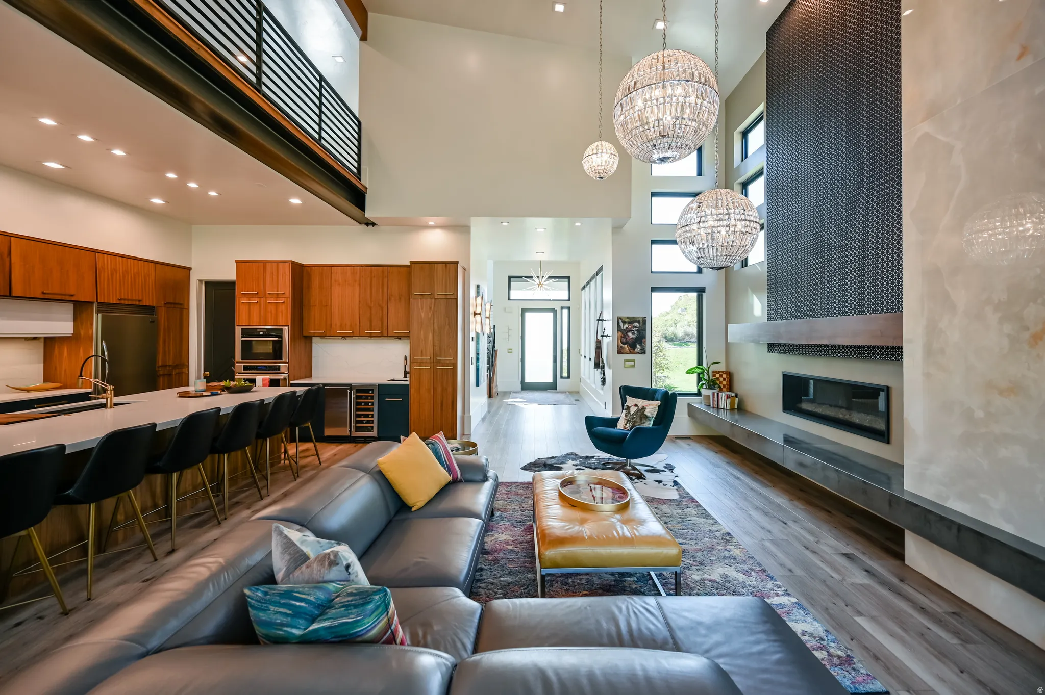 Open-concept living area with soaring ceilings and wood-finish flooring