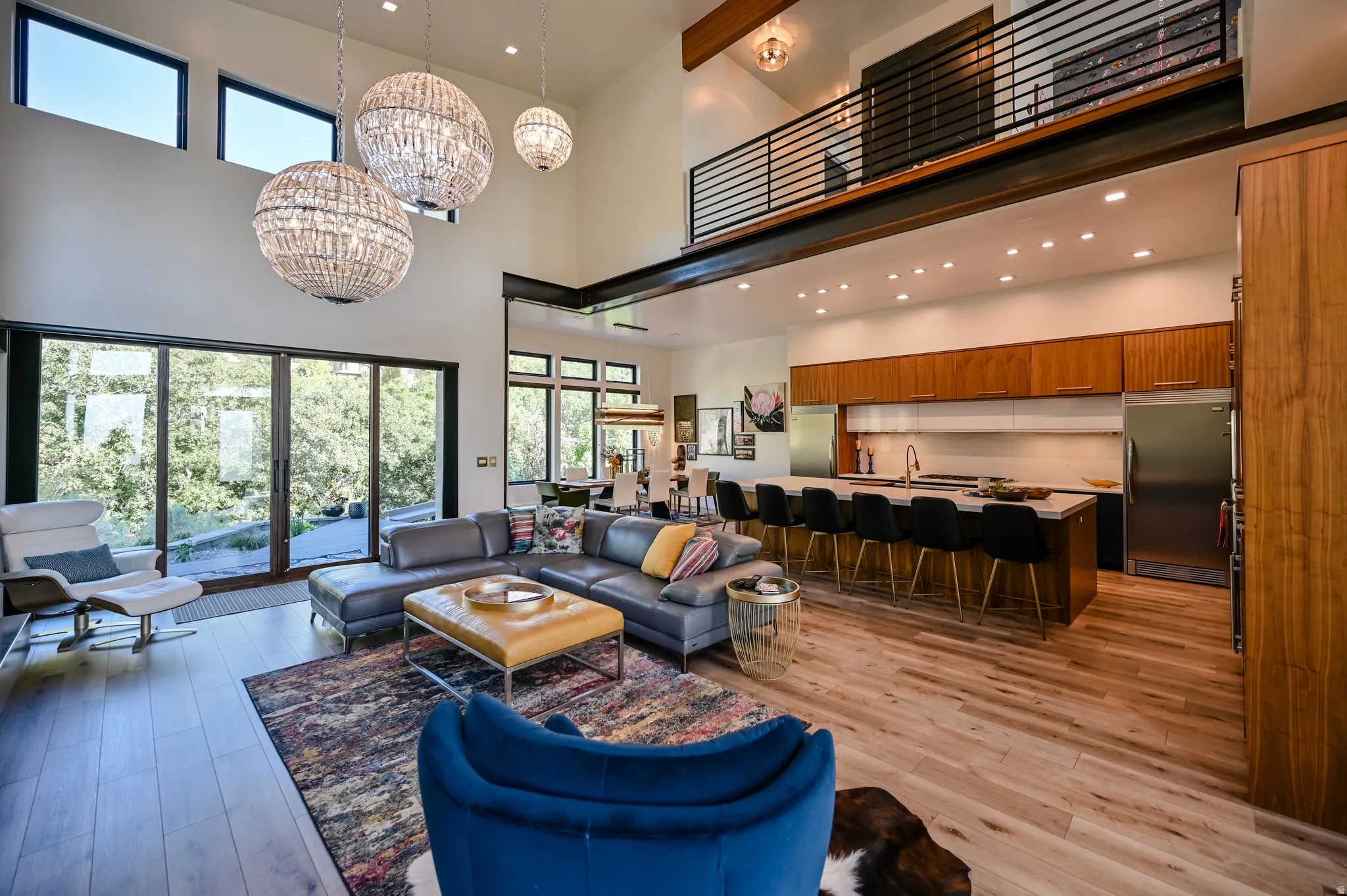 Open-concept living space with high ceilings and wood-finish flooring