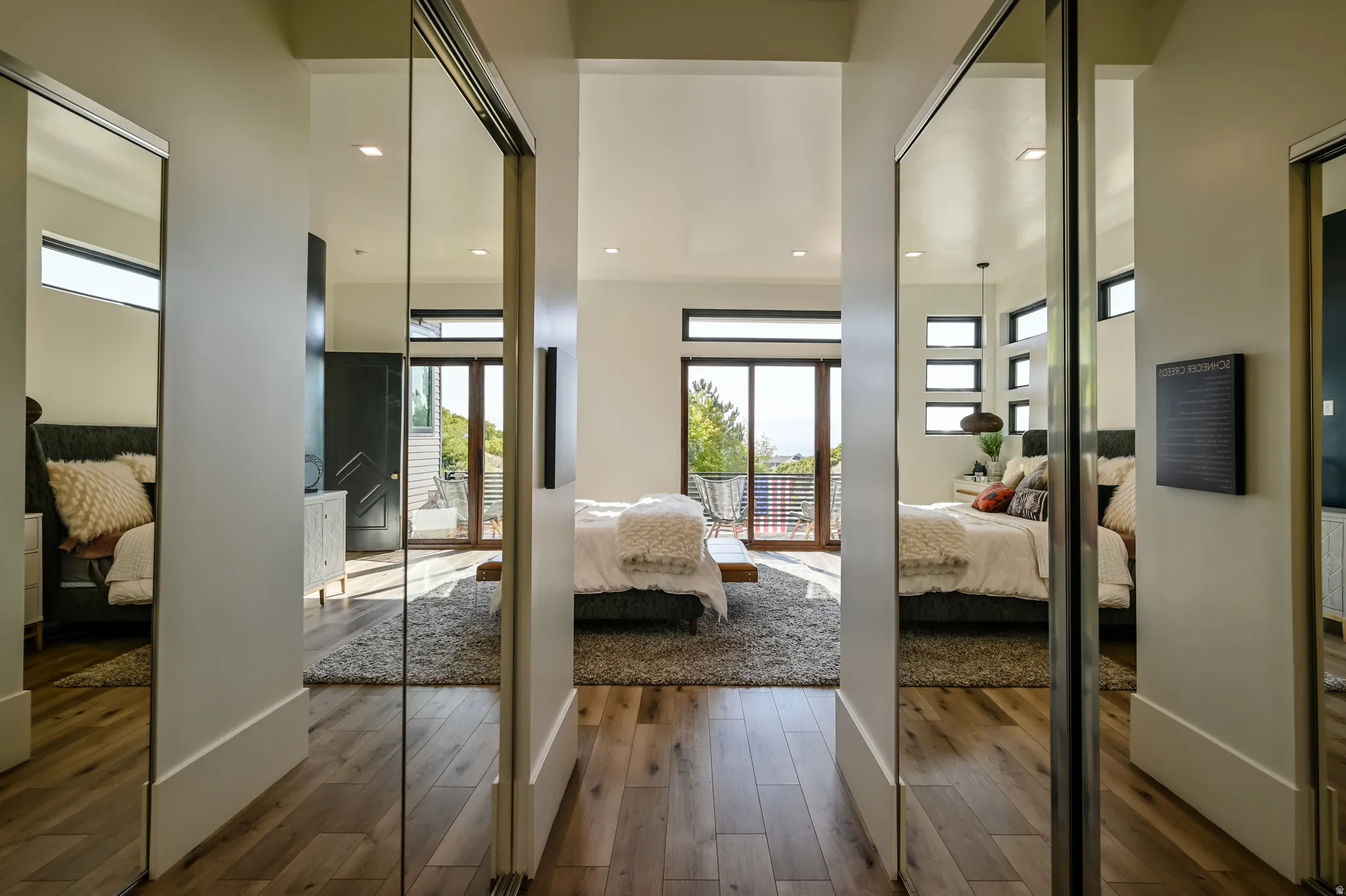 Wide plank wood-finish flooring extending into multiple rooms