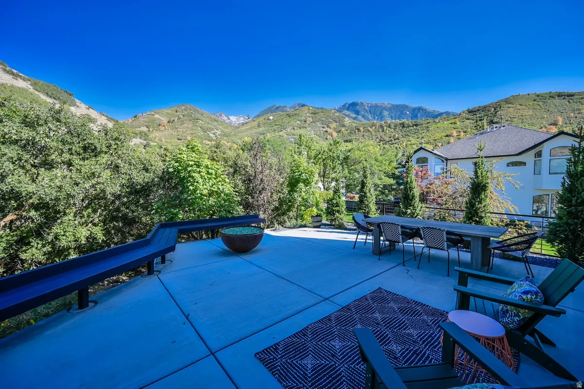 Expansive outdoor patio with concrete surfacing and mountain scenery