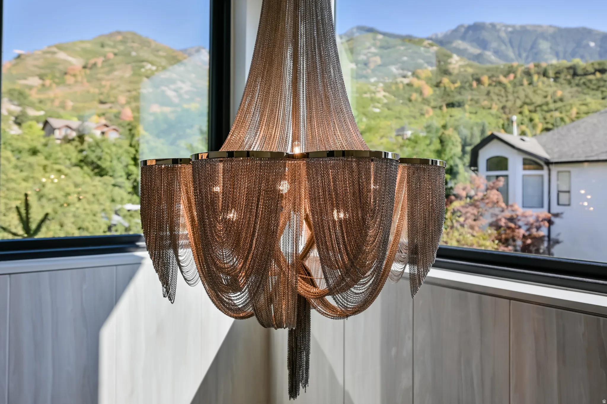 Chain-link chandelier with multiple light sources and gold-tone accents