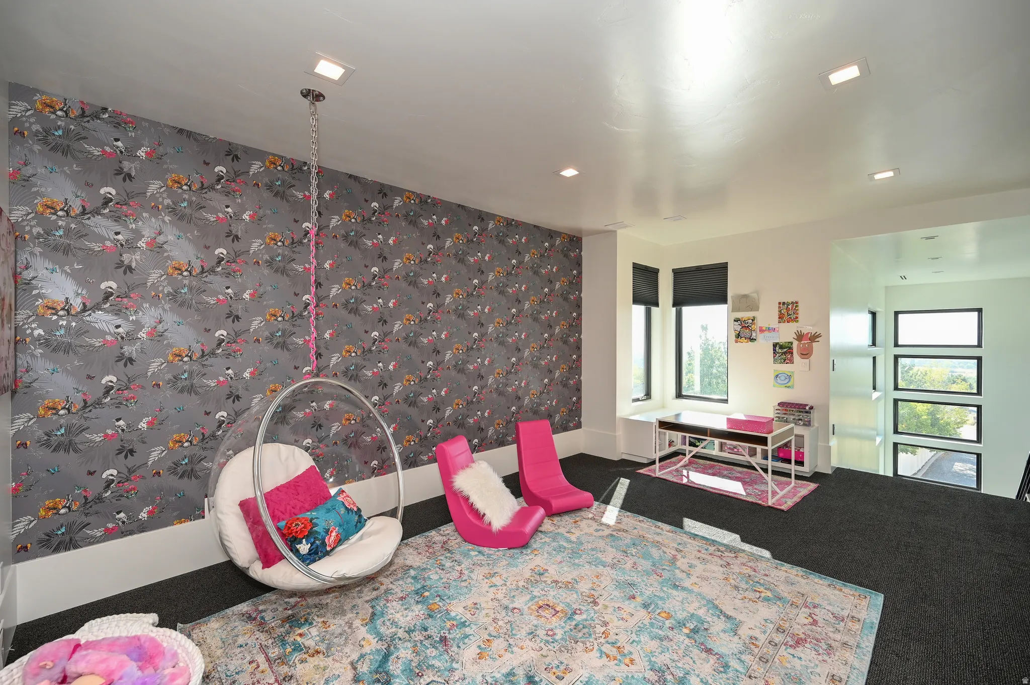 Recessed lighting illuminating a room featuring a patterned accent wall