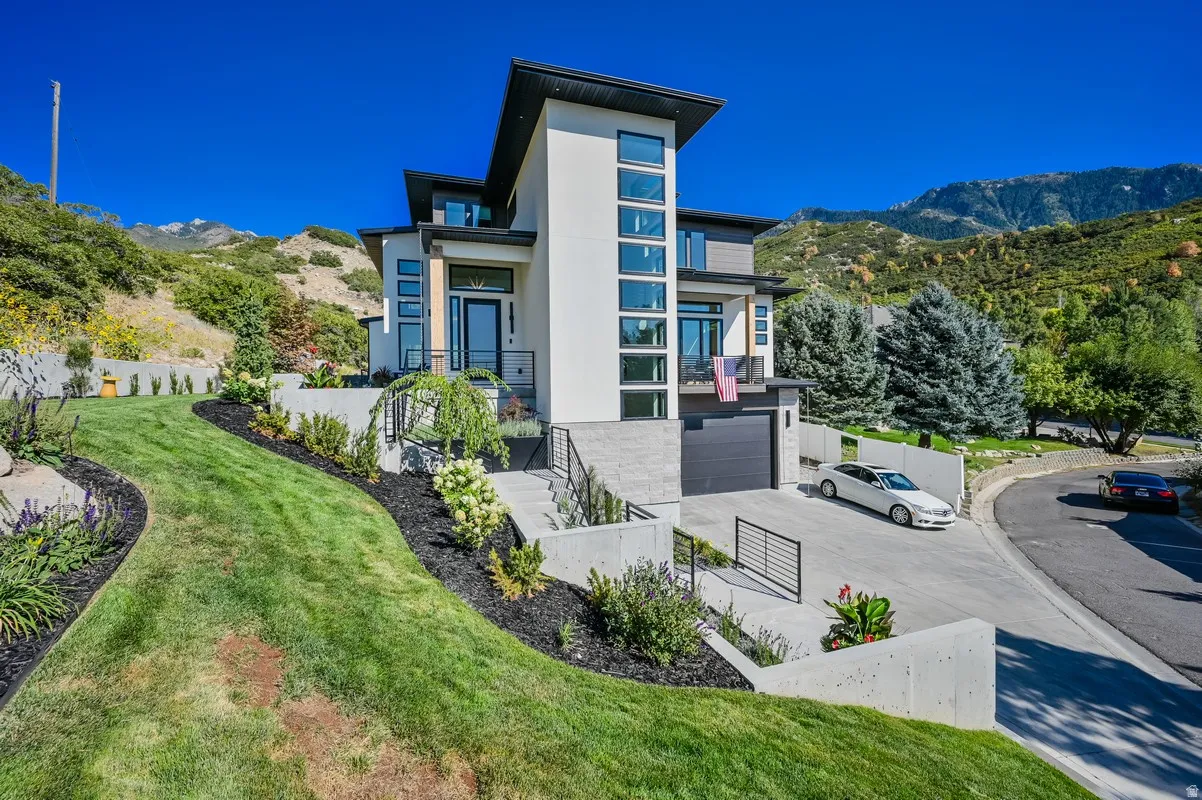 Contemporary multi-level residence featuring a striking architectural design with contrasting white and gray exterior finishes