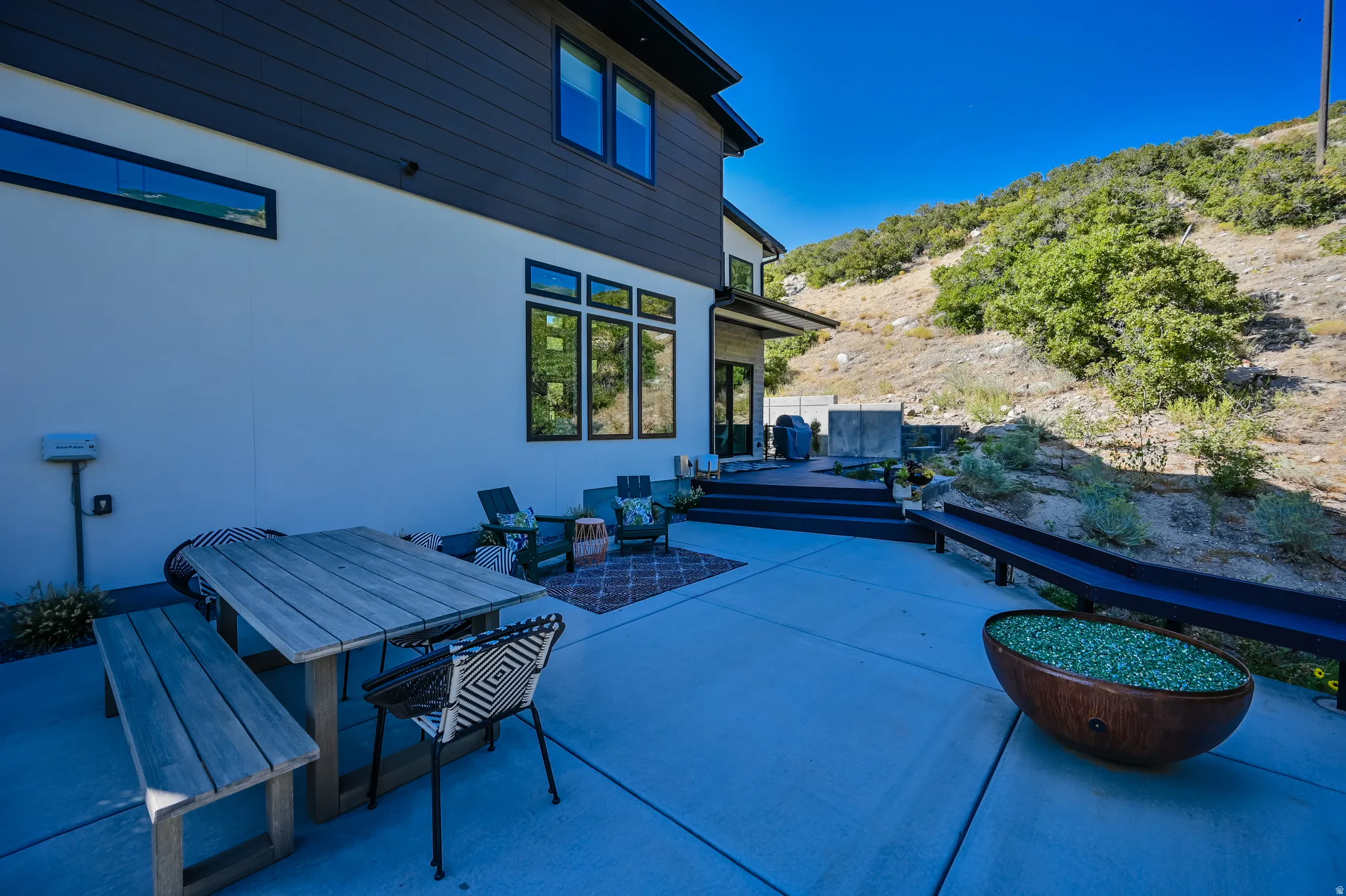 Expansive concrete patio with mountain backdrop