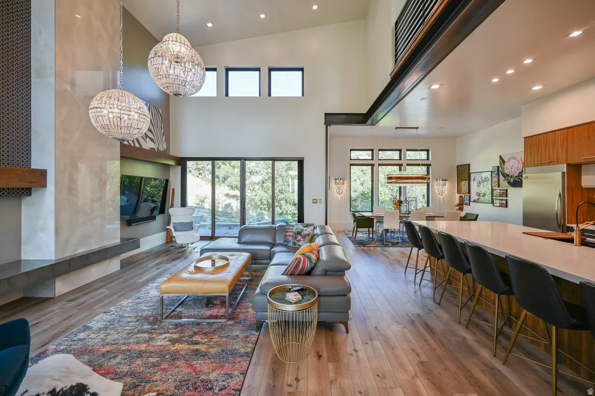 Vaulted ceilings above a spacious open-concept living area with wood-finish flooring