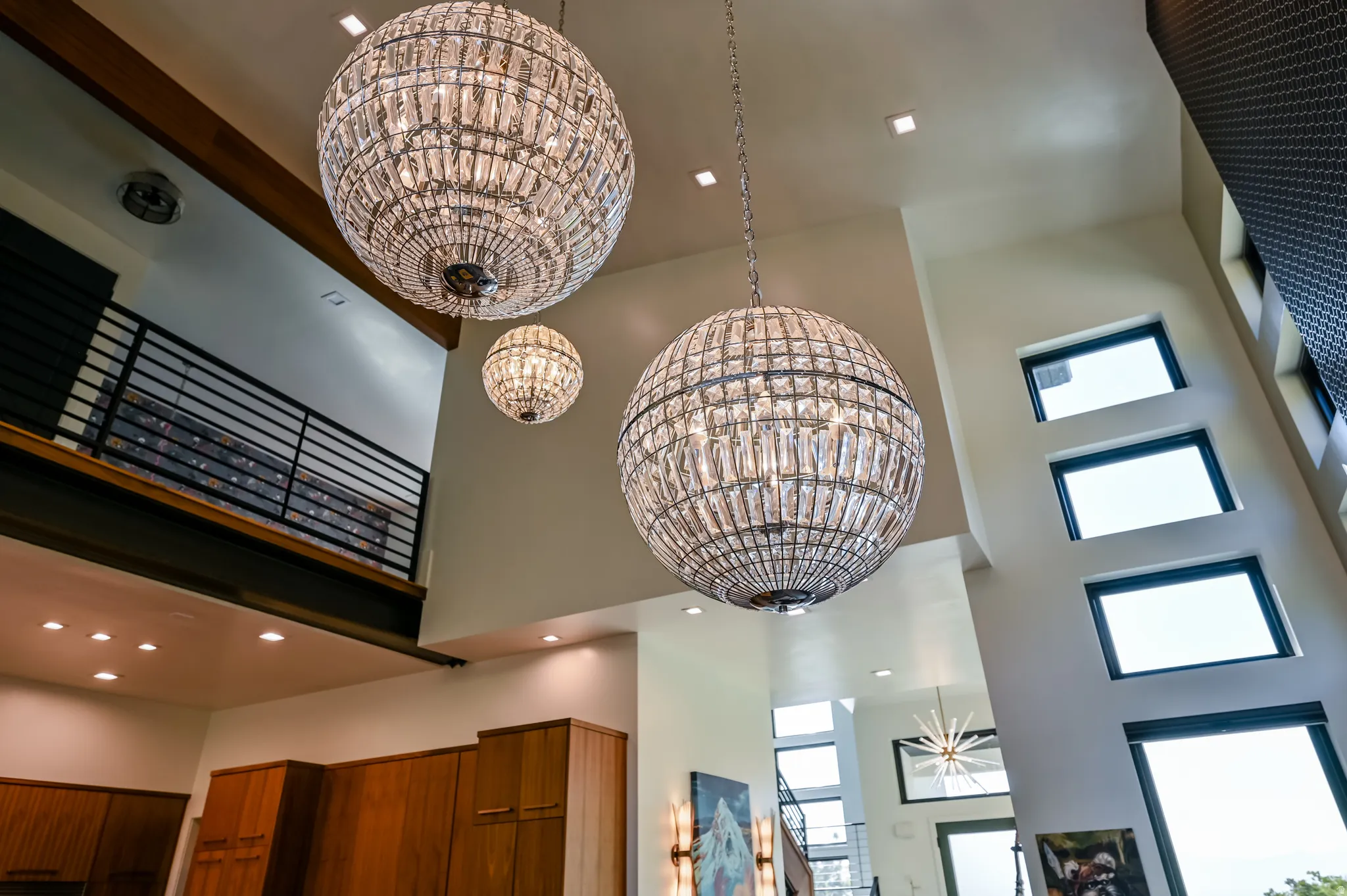 Soaring ceilings featuring three spherical crystal chandeliers