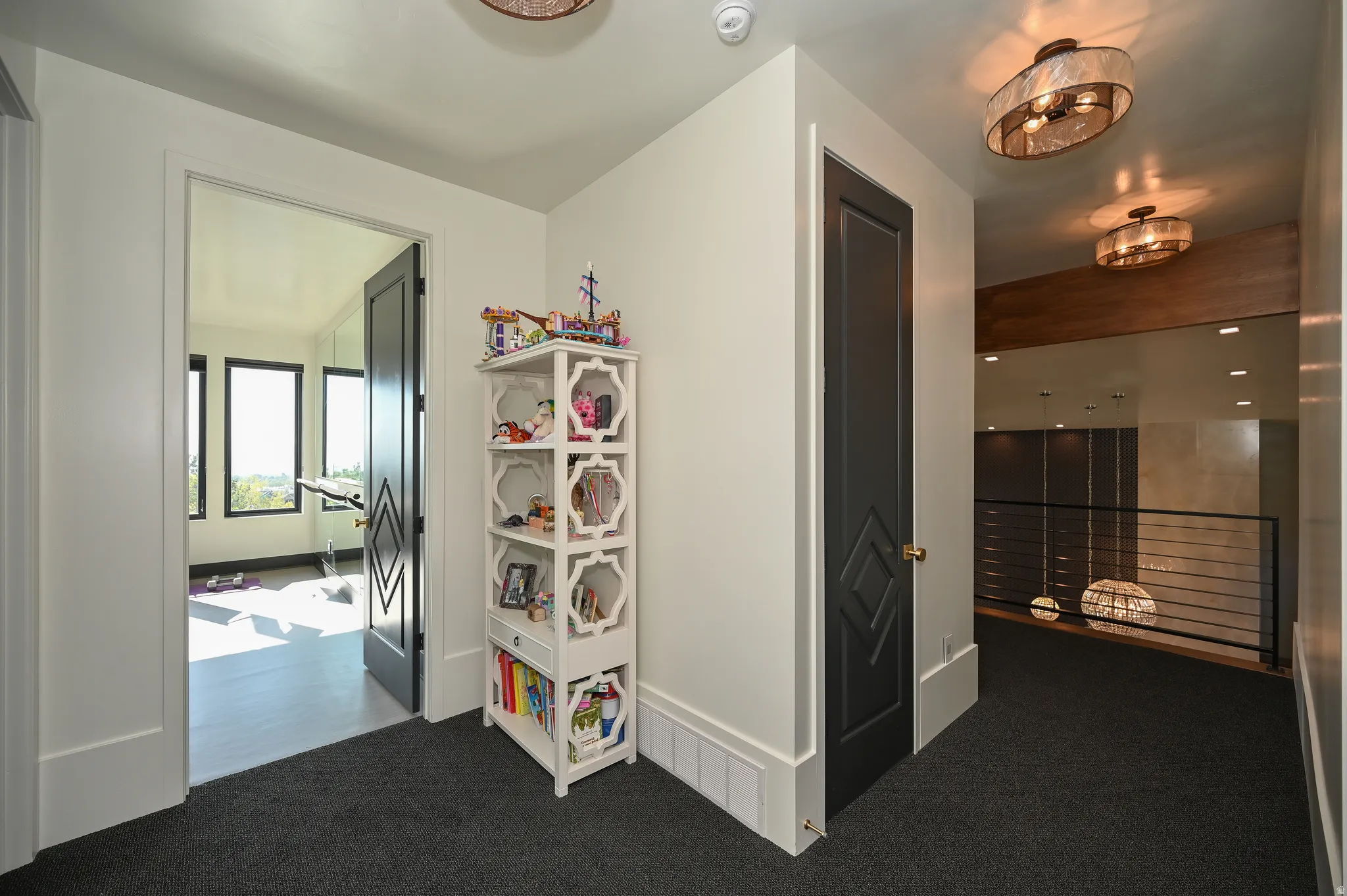 Hallway featuring dark gray carpeting and recessed lighting