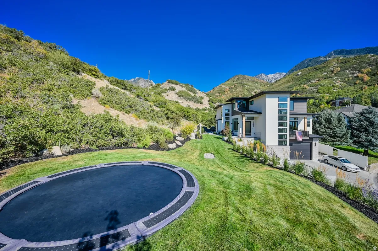 Modern multi-level residence featuring a stucco and siding exterior, expansive windows, and an integrated garage