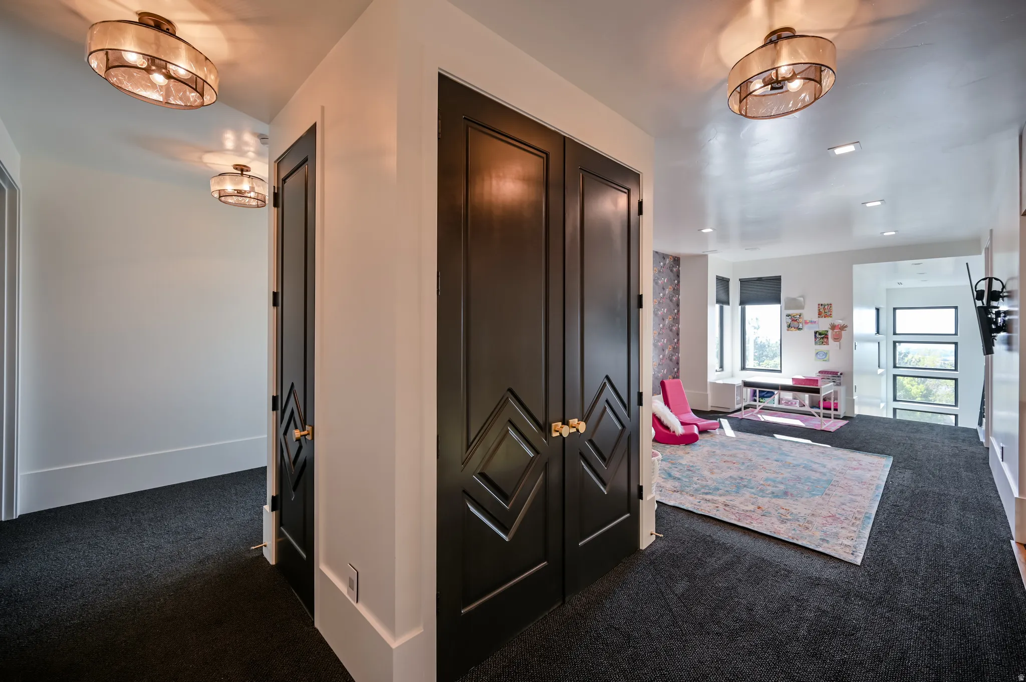 Hallway featuring dark carpet flooring and white walls