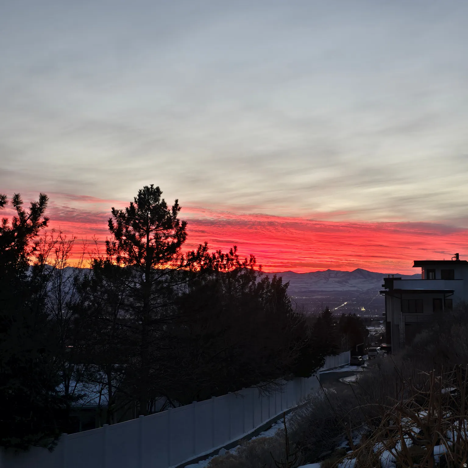Dramatic red and orange sky over distant mountains